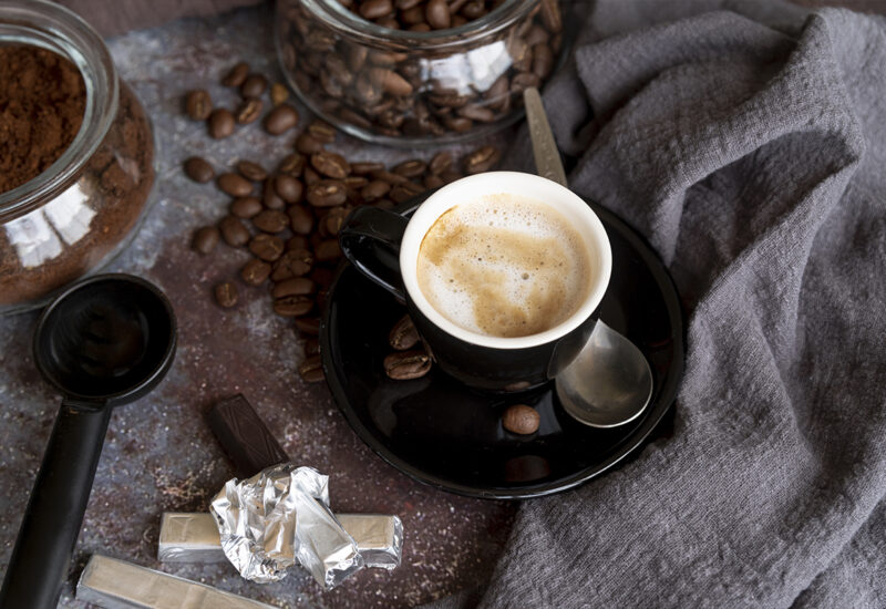 Coffee beans on black background with drink. High quality photo
